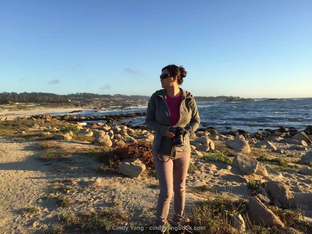 Cindy Yang, photographer, on the Monterey coast with her camera
