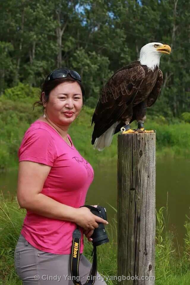 Cindy Yang with a bald eagle, camera in hand