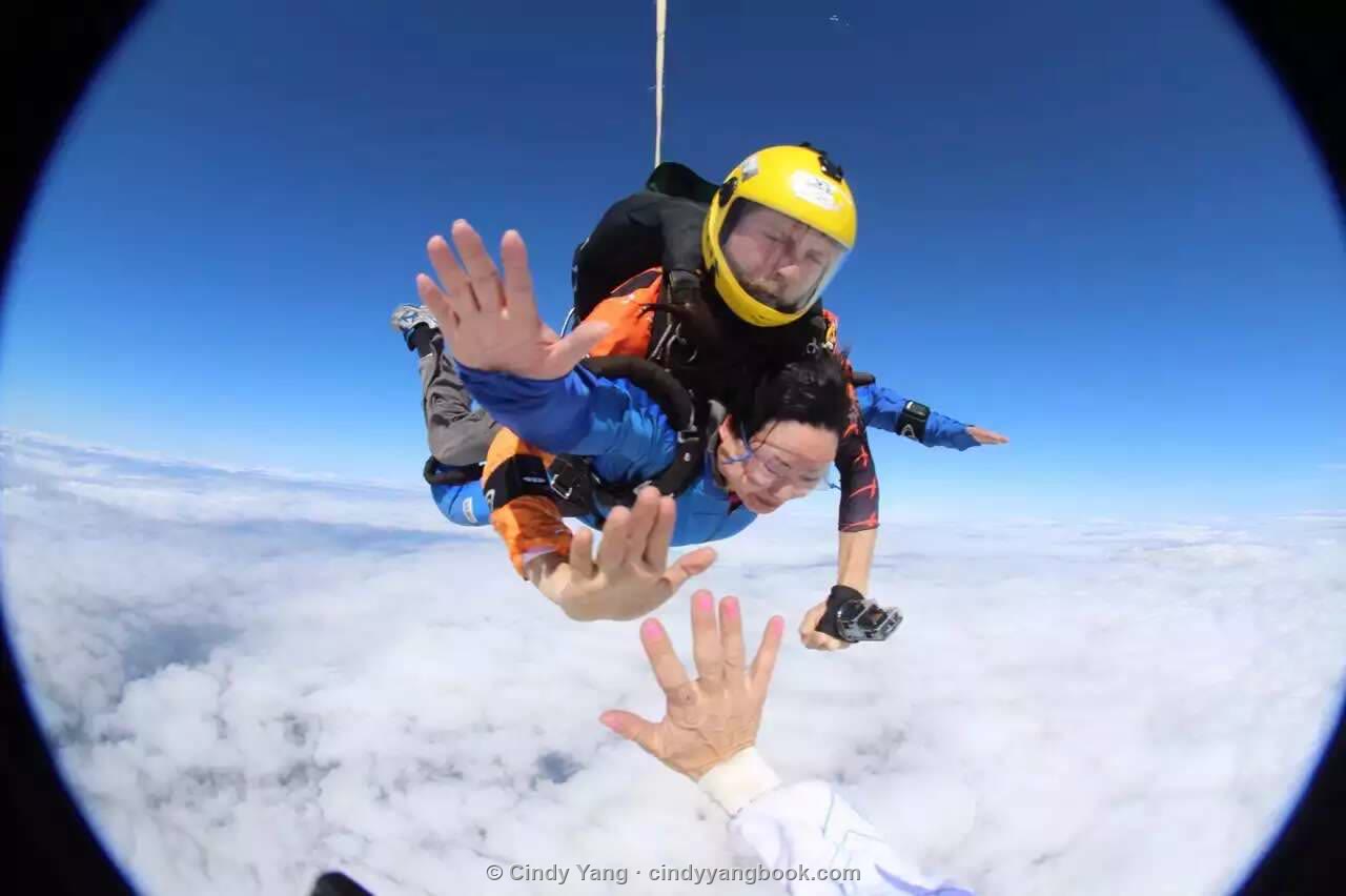 Cindy tandem skydiving above the clouds